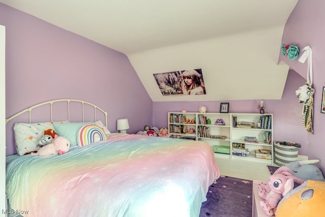 bedroom with carpet floors and vaulted ceiling