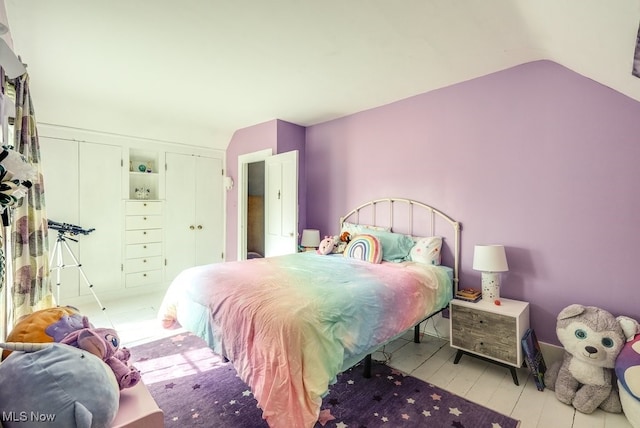 bedroom with lofted ceiling and hardwood / wood-style floors