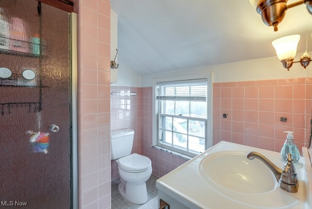 bathroom with toilet, tile walls, vaulted ceiling, and a stall shower