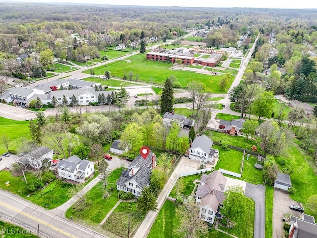 drone / aerial view featuring a view of trees and a residential view