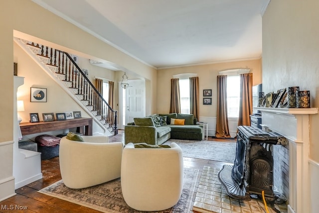 living room with ornamental molding, stairs, hardwood / wood-style floors, and a wealth of natural light
