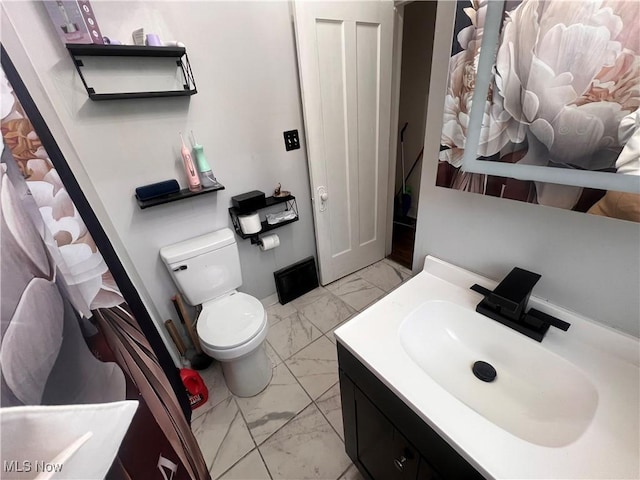 bathroom featuring vanity, toilet, and marble finish floor