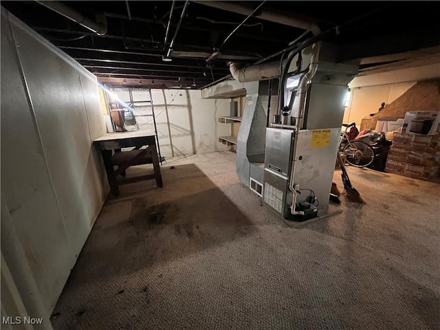 unfinished below grade area featuring heating unit