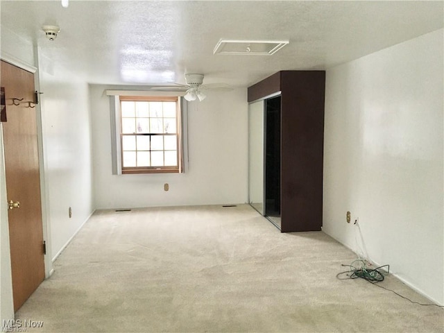 interior space with ceiling fan, carpet flooring, and visible vents