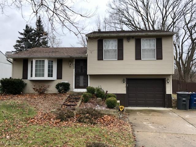 tri-level home with an attached garage and driveway