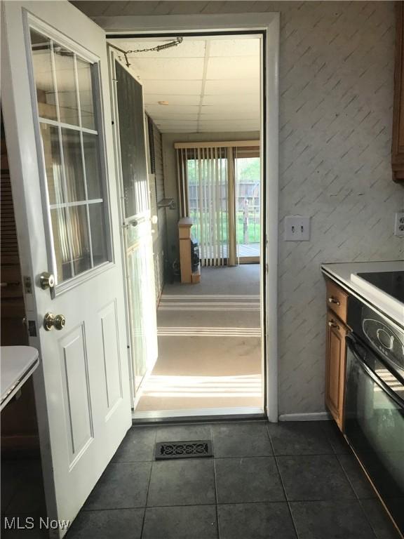 interior space featuring dark tile patterned floors