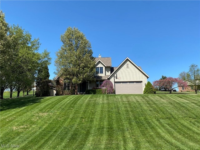exterior space featuring an attached garage and a front yard