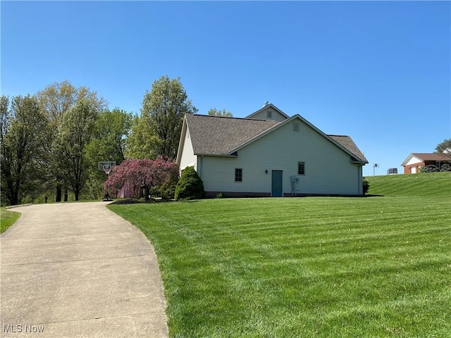 view of side of property with a lawn