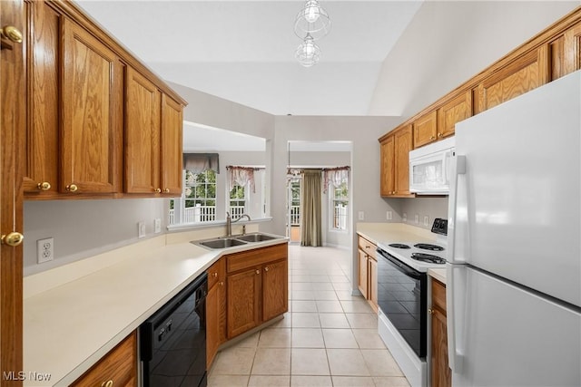 kitchen with light tile patterned flooring, a sink, white appliances, light countertops, and brown cabinetry