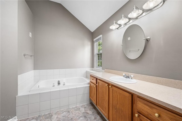 full bath featuring a bath, lofted ceiling, and vanity