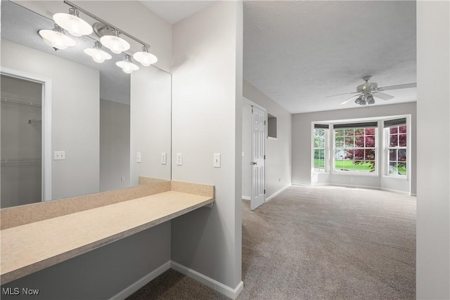 bathroom featuring a ceiling fan and baseboards
