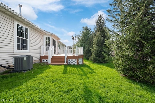 view of yard with central AC and a wooden deck