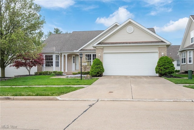 ranch-style house with brick siding, driveway, a front yard, and a garage