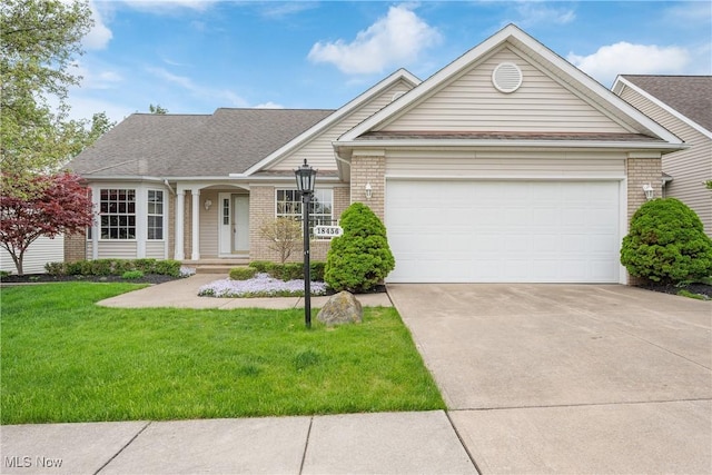 single story home with driveway, roof with shingles, a garage, brick siding, and a front lawn