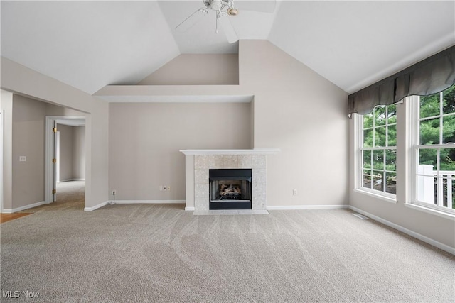 unfurnished living room featuring carpet floors, lofted ceiling, a fireplace, baseboards, and ceiling fan