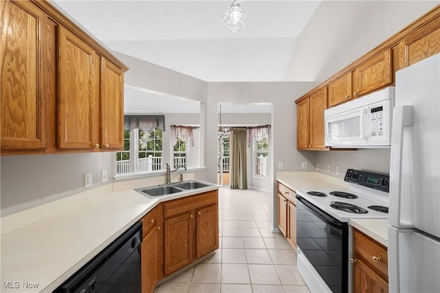 kitchen featuring a sink, light countertops, brown cabinetry, and white appliances