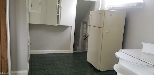 1267 E Pershing St, Salem, OH 44460 - kitchen with baseboards, freestanding refrigerator, white cabinetry, and dark floors