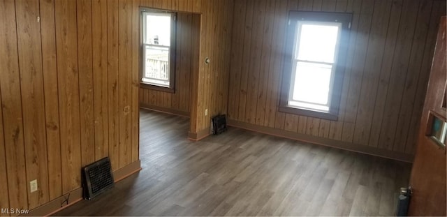 1267 E Pershing St, Salem, OH 44460 - spare room featuring wooden walls, visible vents, and wood finished floors