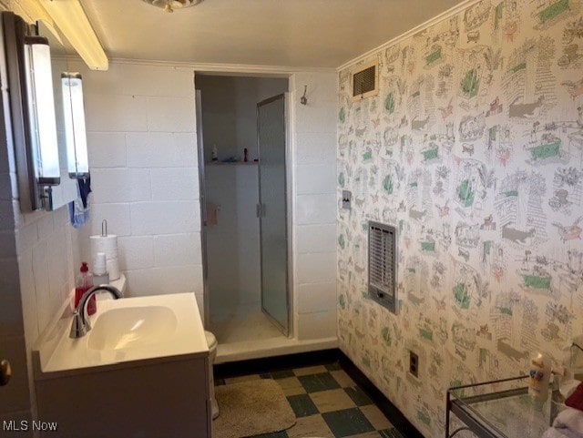 full bathroom with vanity, visible vents, heating unit, tile patterned floors, and a stall shower