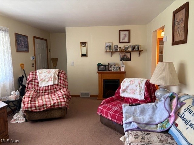 carpeted living room featuring baseboards and visible vents