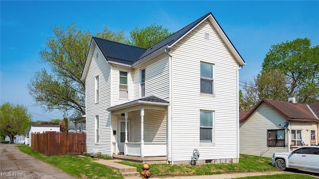 view of front of property with fence and metal roof