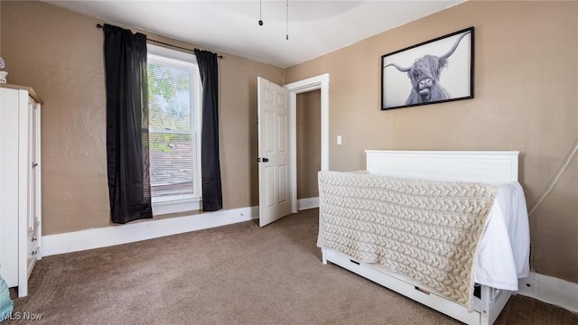 carpeted bedroom with baseboards