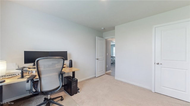 home office featuring baseboards and light colored carpet