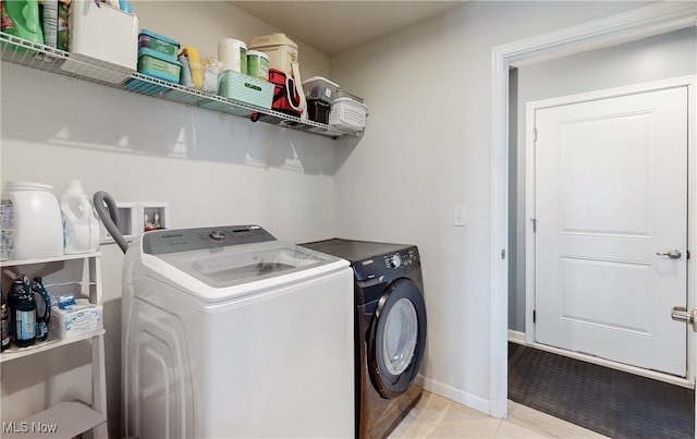 washroom with laundry area, independent washer and dryer, and light tile patterned flooring