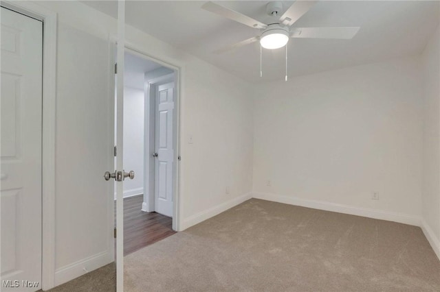 spare room with carpet floors, baseboards, and ceiling fan