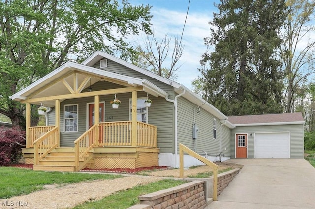 view of front of house with an attached garage, covered porch, and concrete driveway