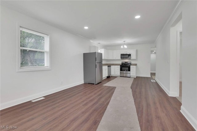 unfurnished living room featuring crown molding, recessed lighting, visible vents, and dark wood-type flooring
