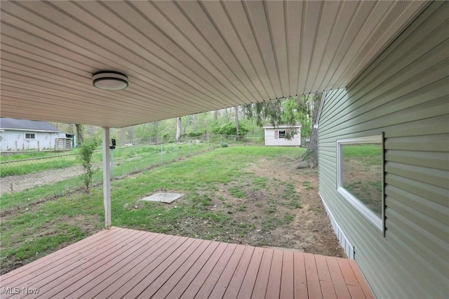 deck with a lawn and a fenced backyard