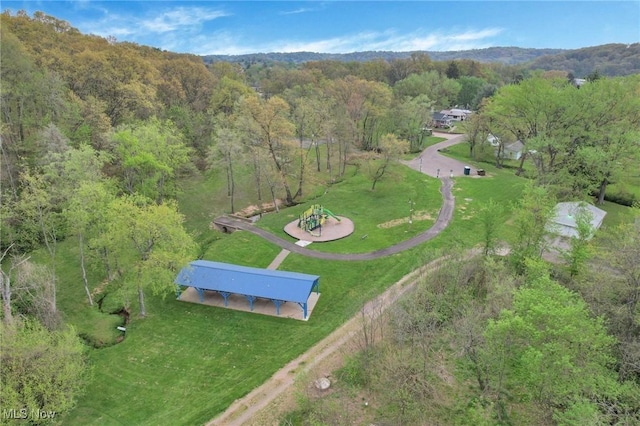 birds eye view of property with a view of trees