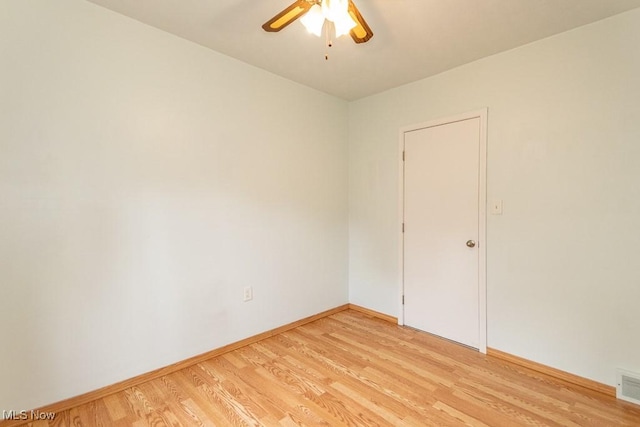 unfurnished room featuring baseboards, ceiling fan, light wood finished floors, and visible vents