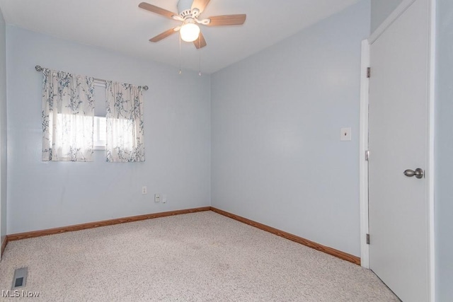 unfurnished room with carpet floors, a ceiling fan, baseboards, and visible vents