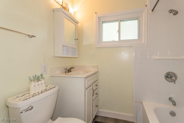 bathroom featuring vanity, shower / bathtub combination, and toilet