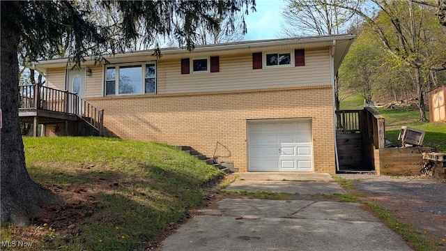 view of side of property featuring stairway, brick siding, an attached garage, and aphalt driveway