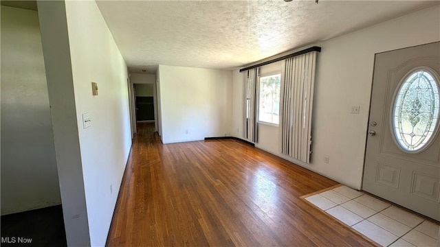 entrance foyer with a textured ceiling and wood finished floors