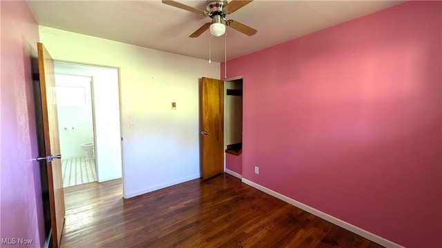 unfurnished bedroom featuring baseboards and wood finished floors
