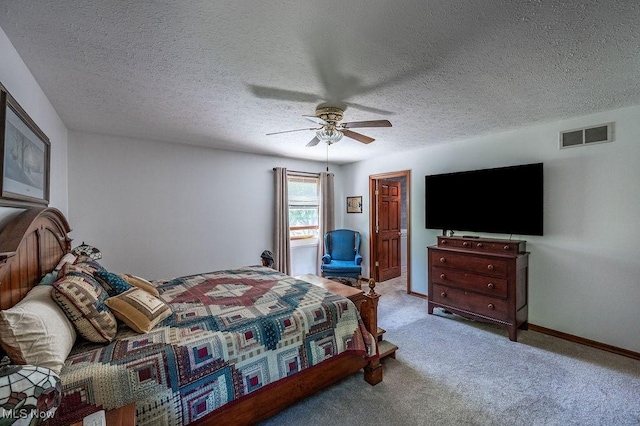carpeted bedroom featuring baseboards, a ceiling fan, a textured ceiling, and visible vents