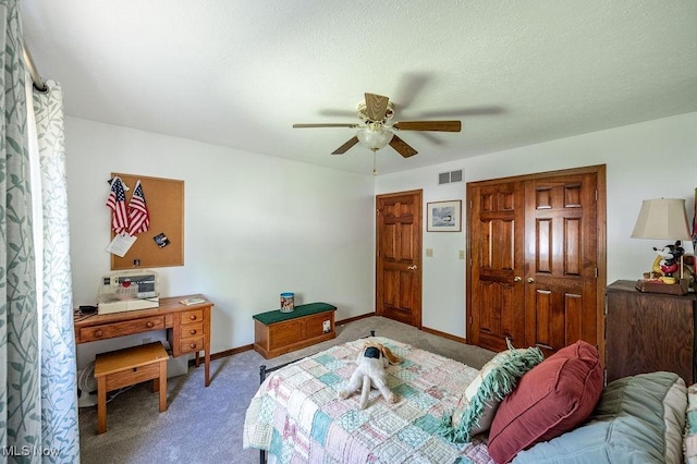 bedroom with visible vents, carpet floors, a closet, baseboards, and ceiling fan