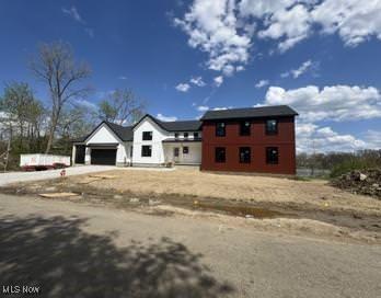 view of front of property featuring an attached garage and concrete driveway