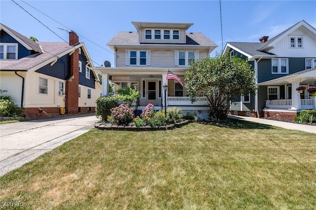 traditional style home with a porch and a front yard