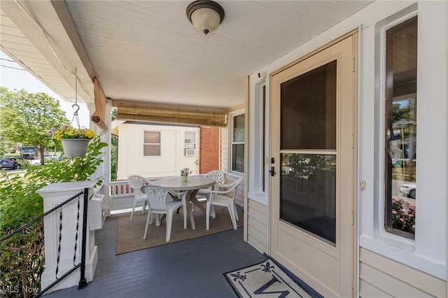 exterior space with a porch and outdoor dining area