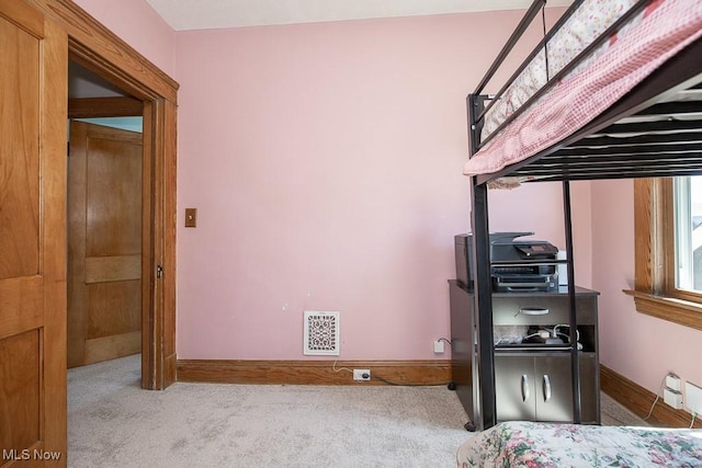 carpeted bedroom with baseboards and visible vents