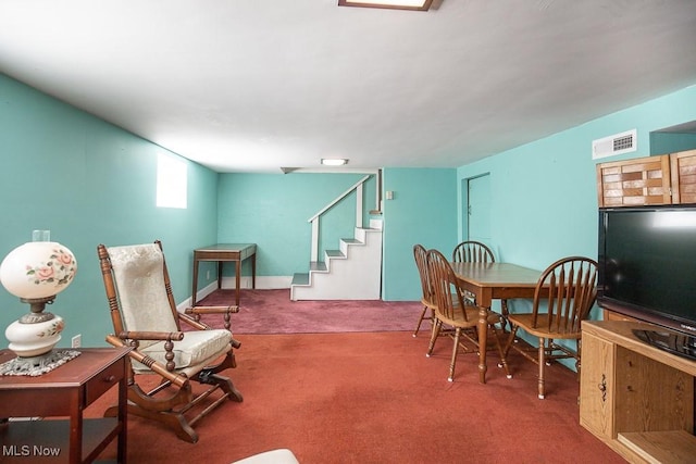 dining area with carpet floors, stairs, and visible vents