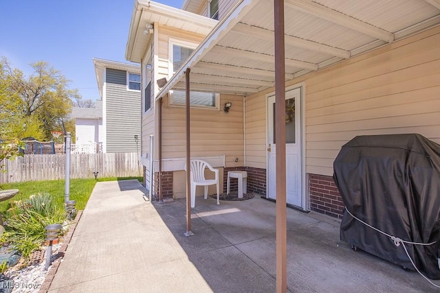 view of patio with fence and area for grilling