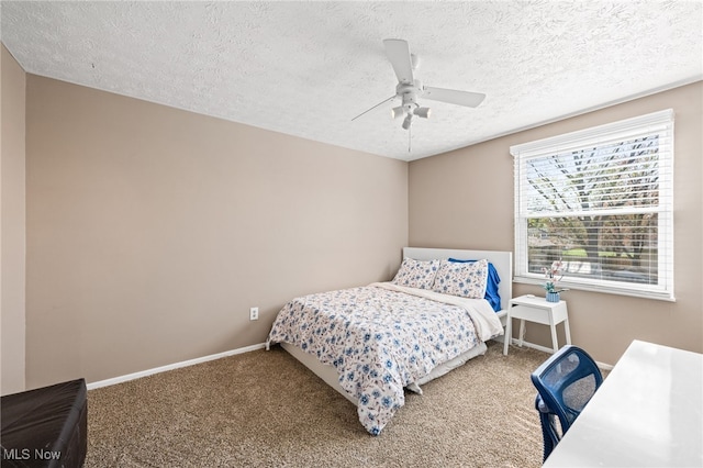 carpeted bedroom with a ceiling fan, a textured ceiling, and baseboards
