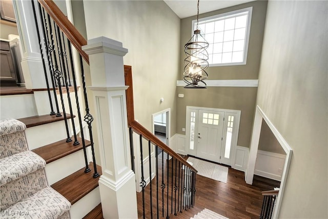 2716 Rocky Ridge Dr, Westlake, OH 44145 - foyer entrance with a wainscoted wall, dark wood-style flooring, a high ceiling, and stairs