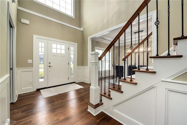 2716 Rocky Ridge Dr, Westlake, OH 44145 - foyer with a wainscoted wall, dark wood-type flooring, a decorative wall, and stairway